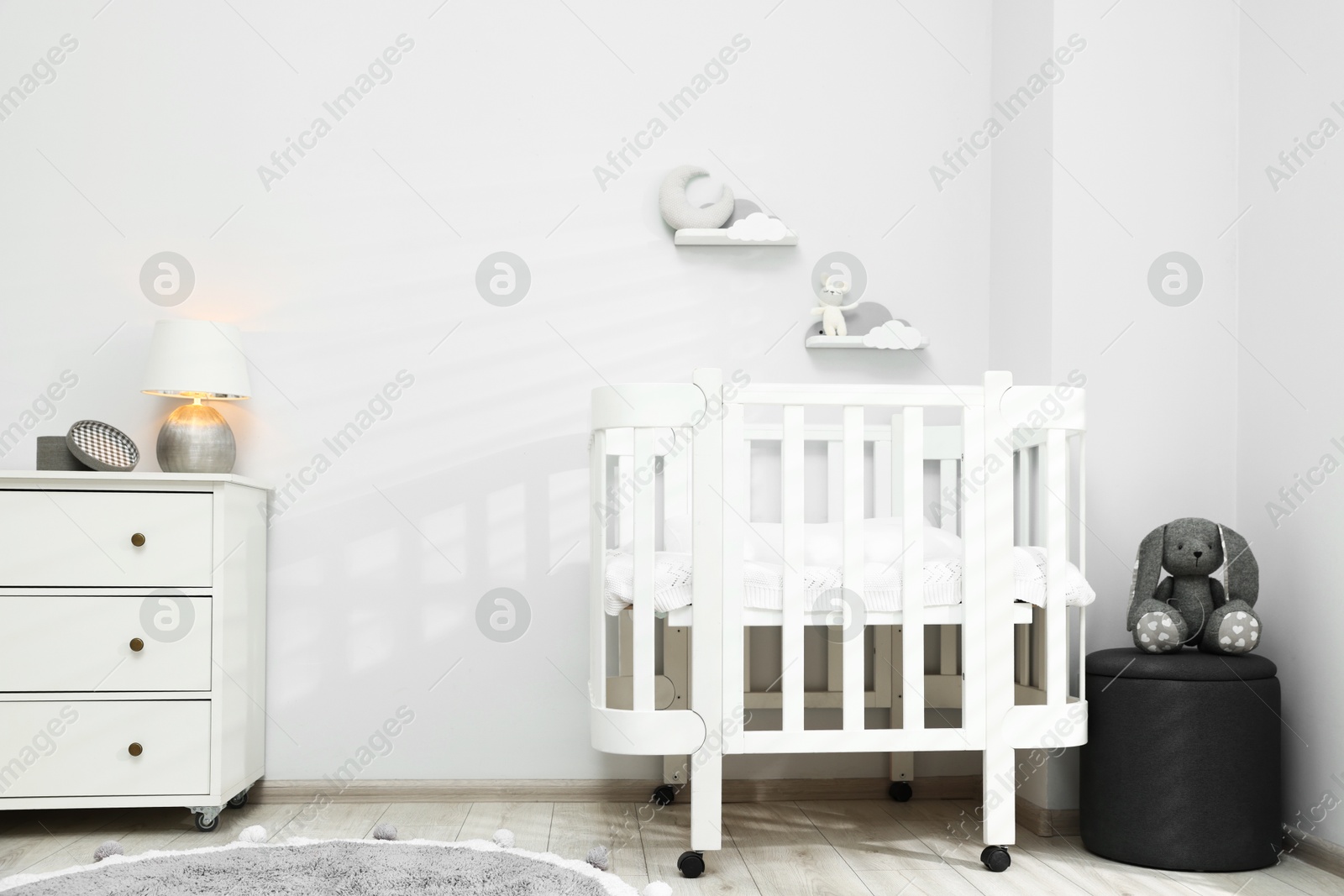 Stylish baby room interior with comfortable crib and other furniture Photo of Stylish baby room interior with comfortable crib and other furniture