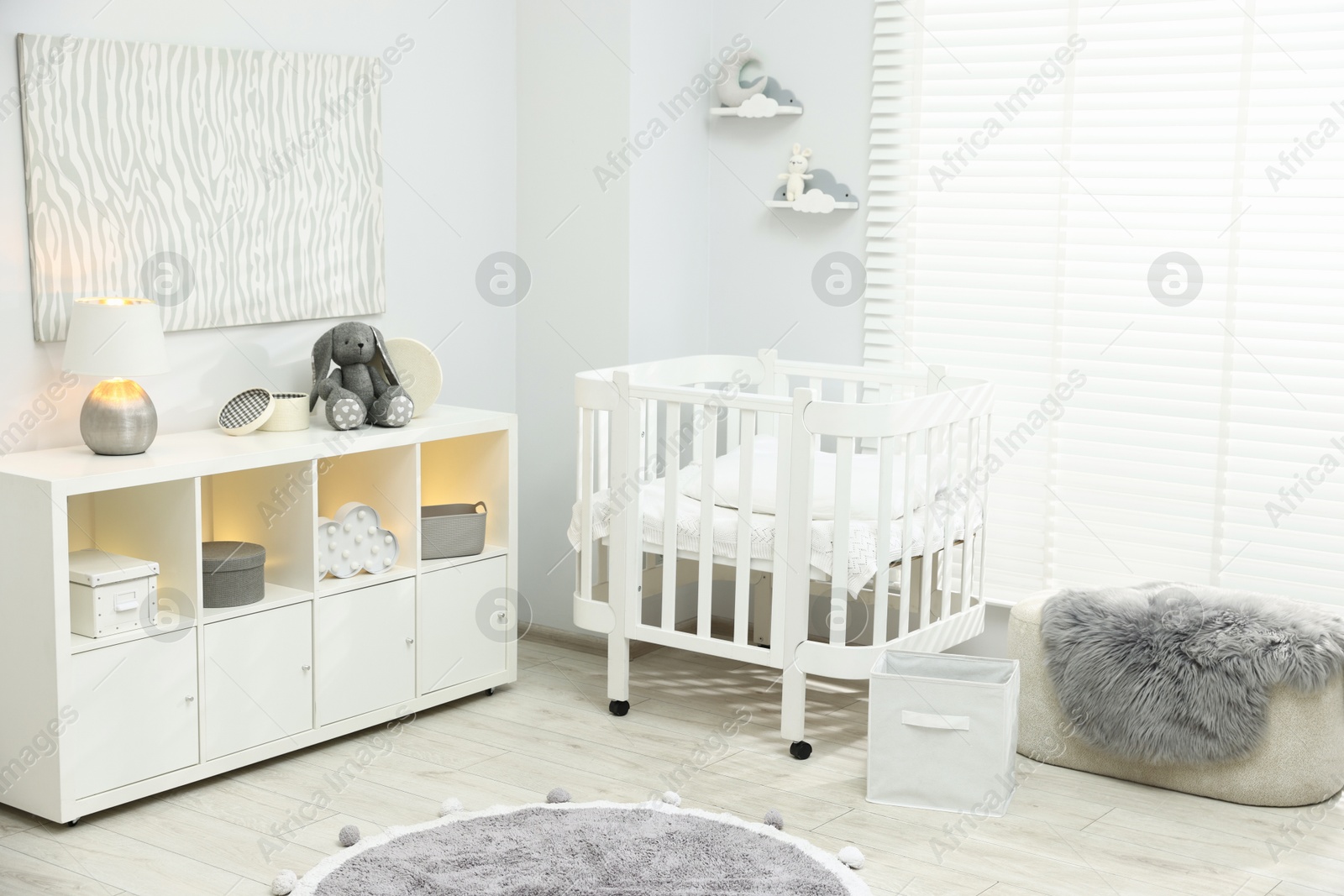 Beautiful baby room interior with stylish crib, other furniture and toys Photo of Beautiful baby room interior with stylish crib, other furniture and toys