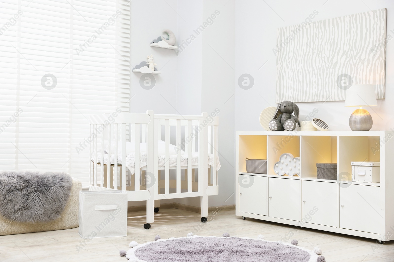 Beautiful baby room interior with stylish crib, other furniture and toys Photo of Beautiful baby room interior with stylish crib, other furniture and toys