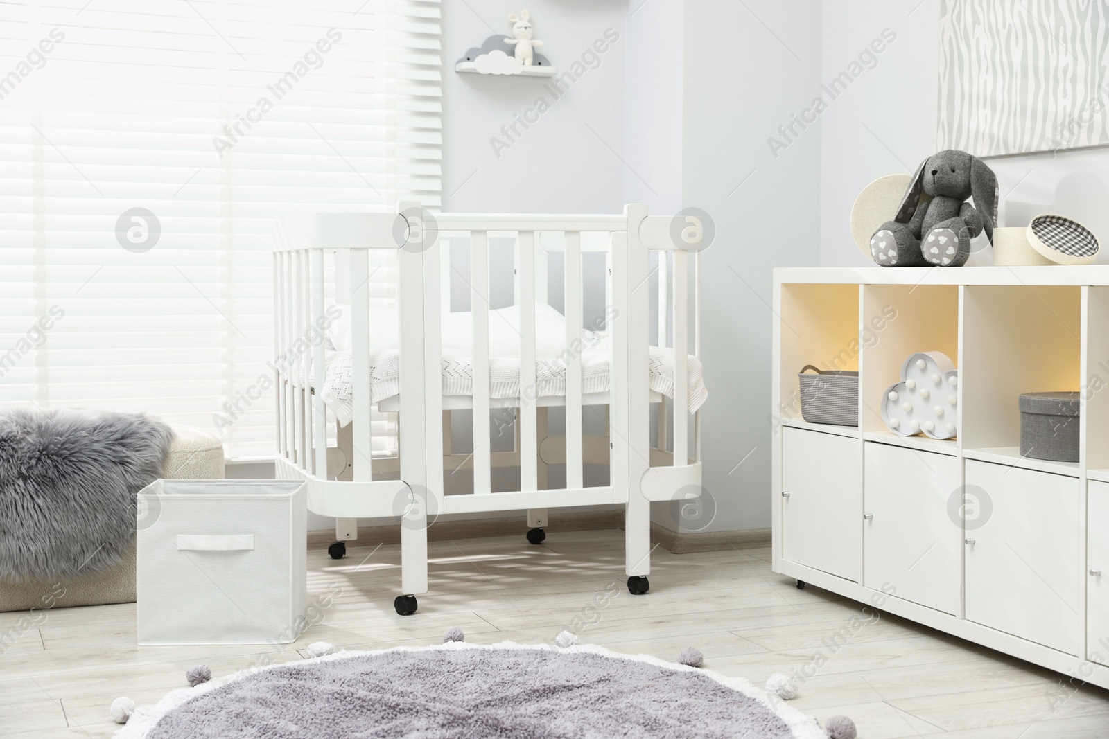 Beautiful baby room interior with stylish crib, other furniture and toys Photo of Beautiful baby room interior with stylish crib, other furniture and toys