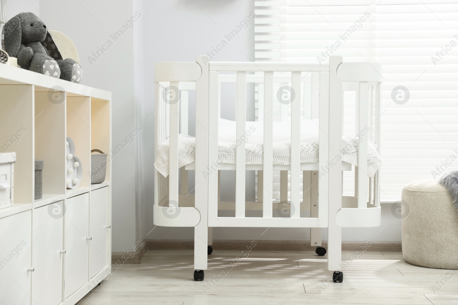 Beautiful baby room interior with stylish crib, other furniture and toys Photo of Beautiful baby room interior with stylish crib, other furniture and toys