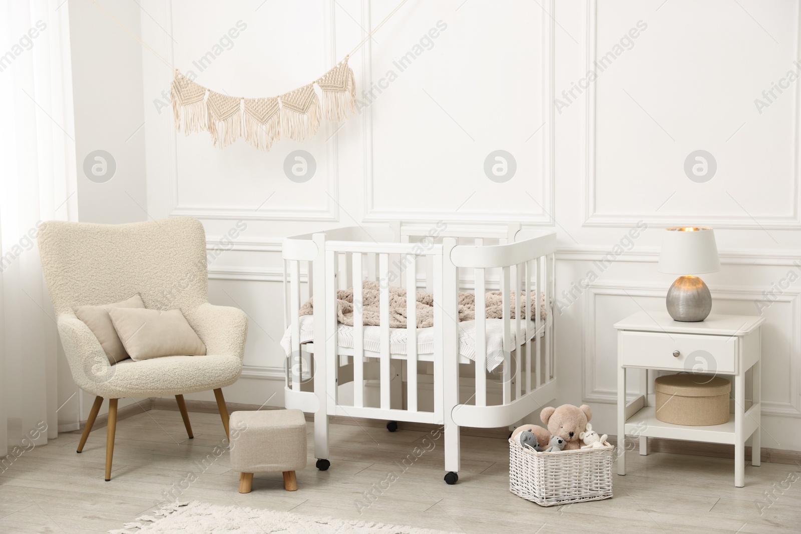 Stylish baby room interior with comfortable crib, armchair and toys Photo of Stylish baby room interior with comfortable crib, armchair and toys