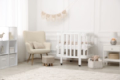 Photo of Baby room interior with crib and other furniture, blurred view