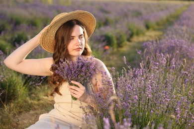 Photo of Beautiful young woman with lavender flowers in field