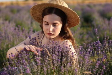 Photo of Beautiful young woman among lavender flowers in field