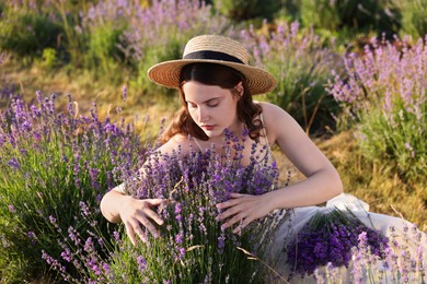Photo of Beautiful young woman among lavender flowers in field