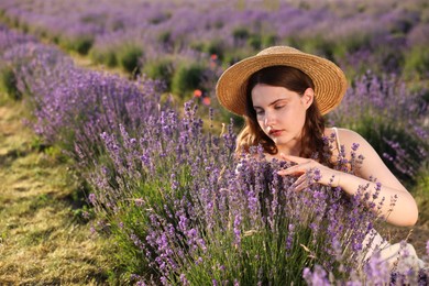 Photo of Beautiful young woman among lavender flowers in field