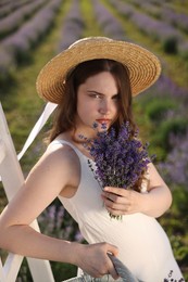 Photo of Beautiful young woman with lavender flowers outdoors