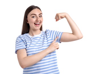 Photo of Strength. Happy woman pointing at her biceps on white background