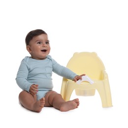Photo of Cute little baby sitting near potty on white background