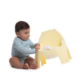 Photo of Cute little baby sitting near potty on white background