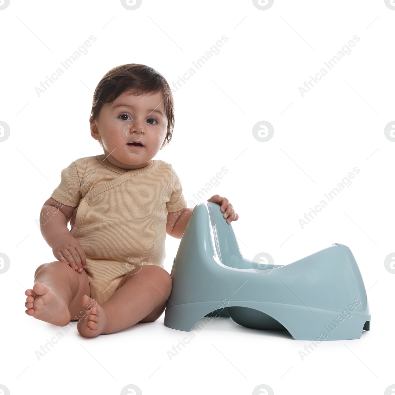 Photo of Cute little baby sitting near potty on white background