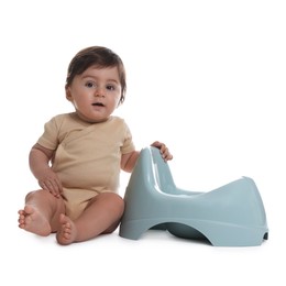 Photo of Cute little baby sitting near potty on white background