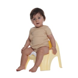 Photo of Cute little baby sitting on potty against white background