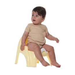 Photo of Cute little baby sitting on potty against white background