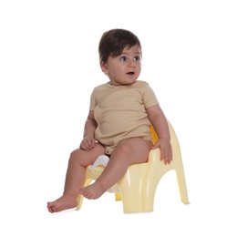 Photo of Cute little baby sitting on potty against white background