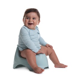 Photo of Cute little baby sitting on potty against white background