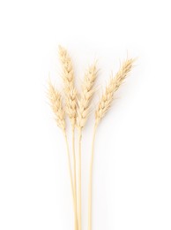 Photo of Dried spikes of wheat isolated on white, top view