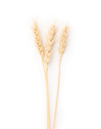 Photo of Dried spikes of wheat isolated on white, top view