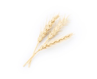 Photo of Dried spikes of wheat isolated on white, top view