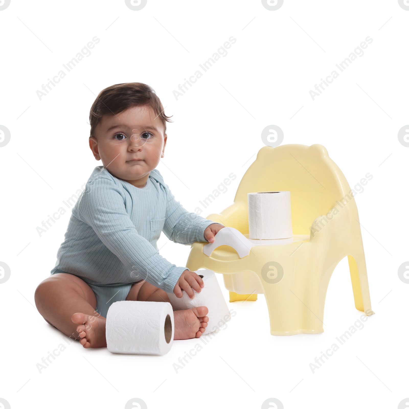 Photo of Cute little baby with rolls of toilet paper near potty on white background