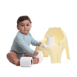 Photo of Cute little baby with rolls of toilet paper near potty on white background
