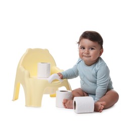 Photo of Cute little baby with rolls of toilet paper near potty on white background