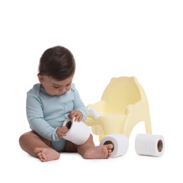 Photo of Cute little baby with rolls of toilet paper near potty on white background