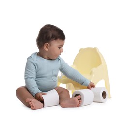 Photo of Cute little baby with rolls of toilet paper near potty on white background