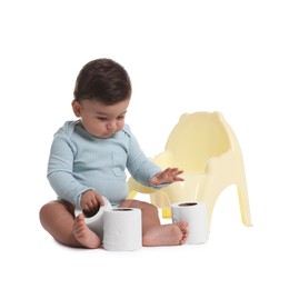 Photo of Cute little baby with rolls of toilet paper near potty on white background