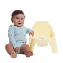 Photo of Cute little baby sitting near potty on white background