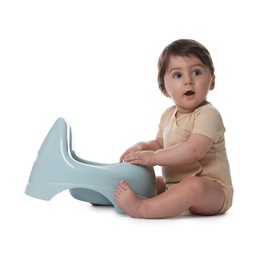 Photo of Cute little baby sitting near potty on white background