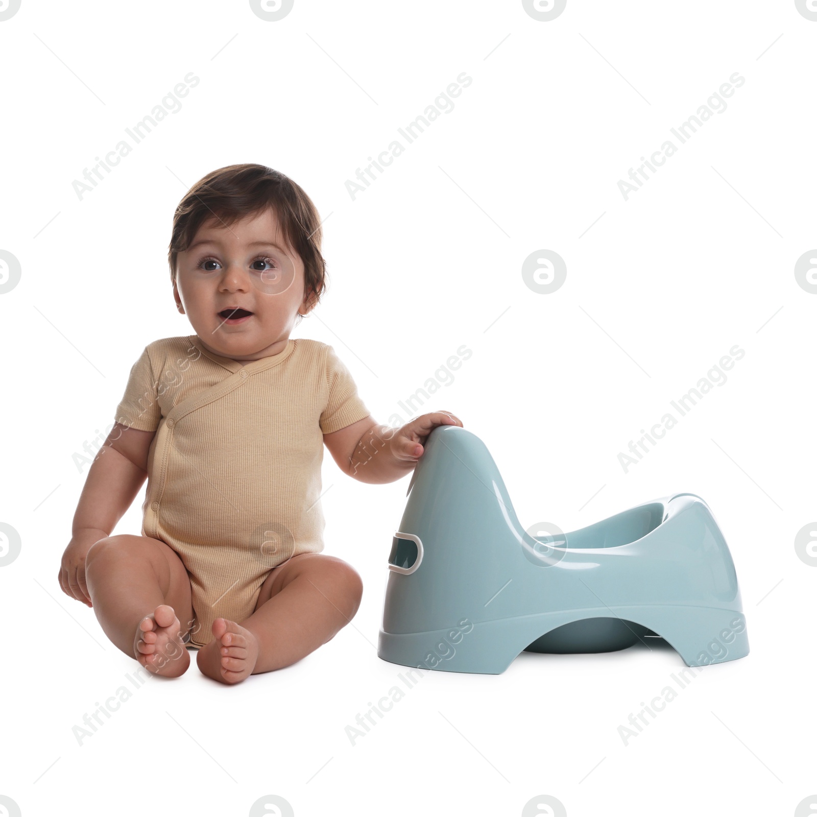 Photo of Cute little baby sitting near potty on white background