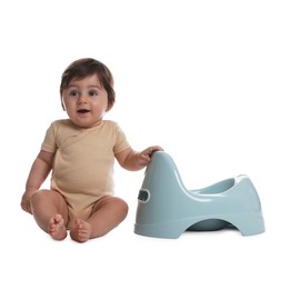 Photo of Cute little baby sitting near potty on white background