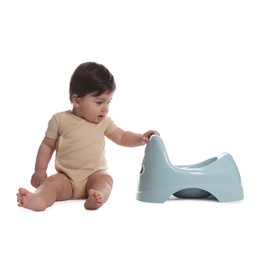 Photo of Cute little baby sitting near potty on white background