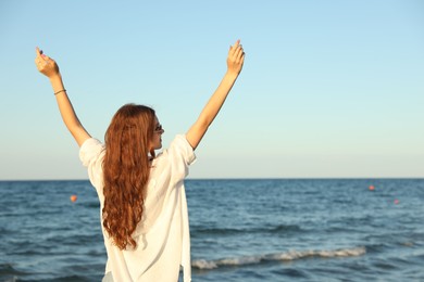 Photo of Beautiful teenage girl near sea, space for text