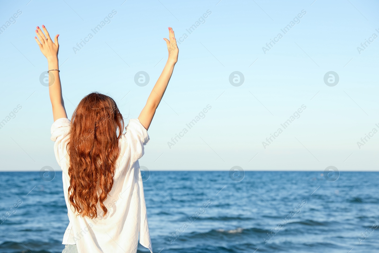 Teenage girl near sea, back view. Space for text Photo of Teenage girl near sea, back view. Space for text