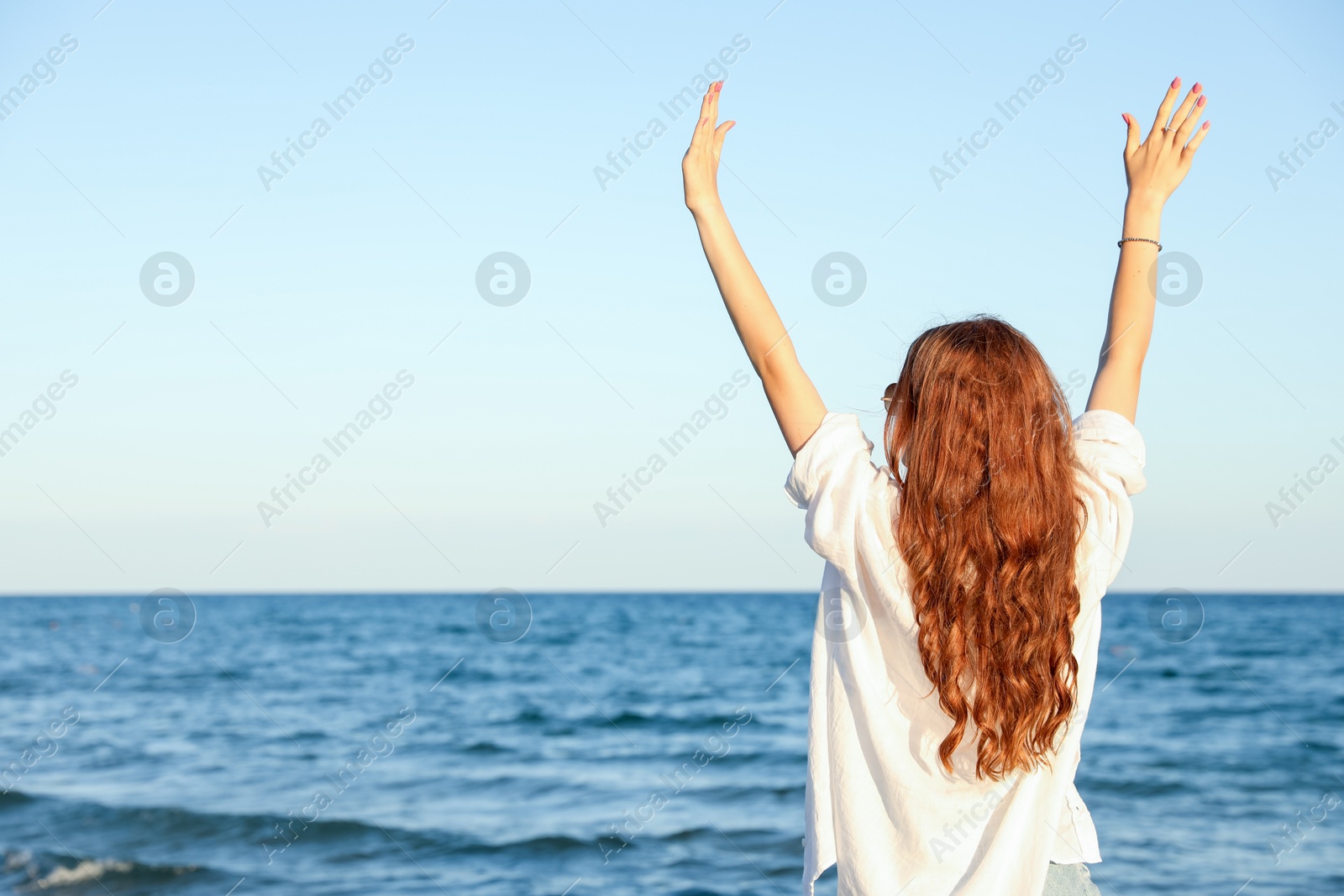 Teenage girl near sea, back view. Space for text Photo of Teenage girl near sea, back view. Space for text