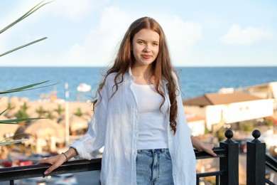 Photo of Portrait of beautiful teenage girl at sea resort