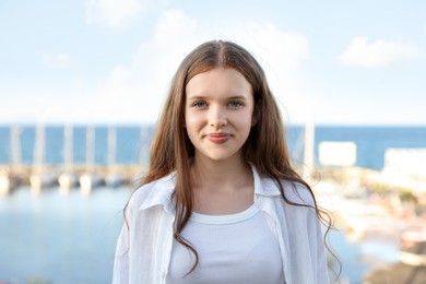 Photo of Portrait of beautiful teenage girl at sea resort