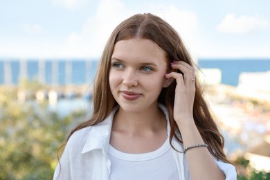 Photo of Portrait of beautiful teenage girl at sea resort