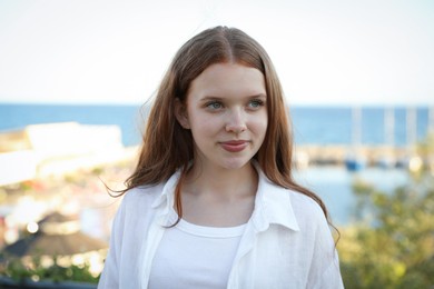 Photo of Portrait of beautiful teenage girl at sea resort