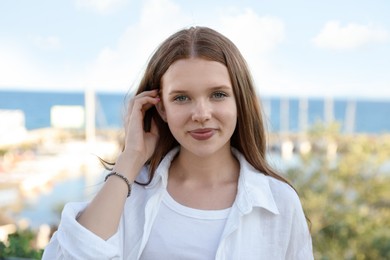 Photo of Portrait of beautiful teenage girl at sea resort