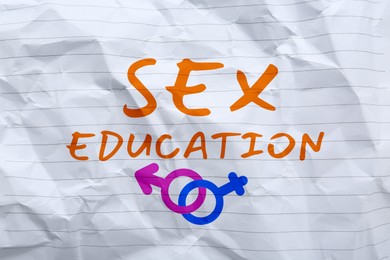 Image of Sex Education inscription, male and female gender symbols on crumpled paper