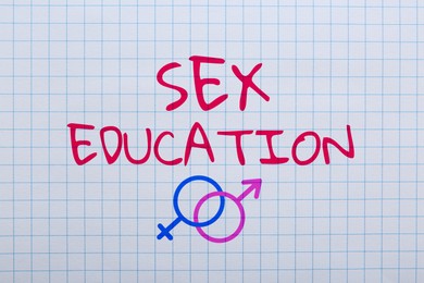 Image of Sex Education inscription, male and female gender symbols on squared paper