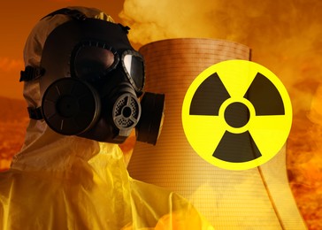 Image of Radioactive hazard, warning sign. Man in hazmat suit and gas mask against industrial plant