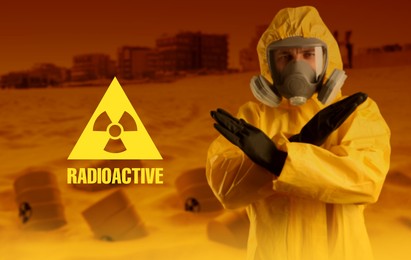 Image of Radioactive hazard. Man in hazmat suit and gas mask blocking way to polluted city. Barrels with warning signs behind him