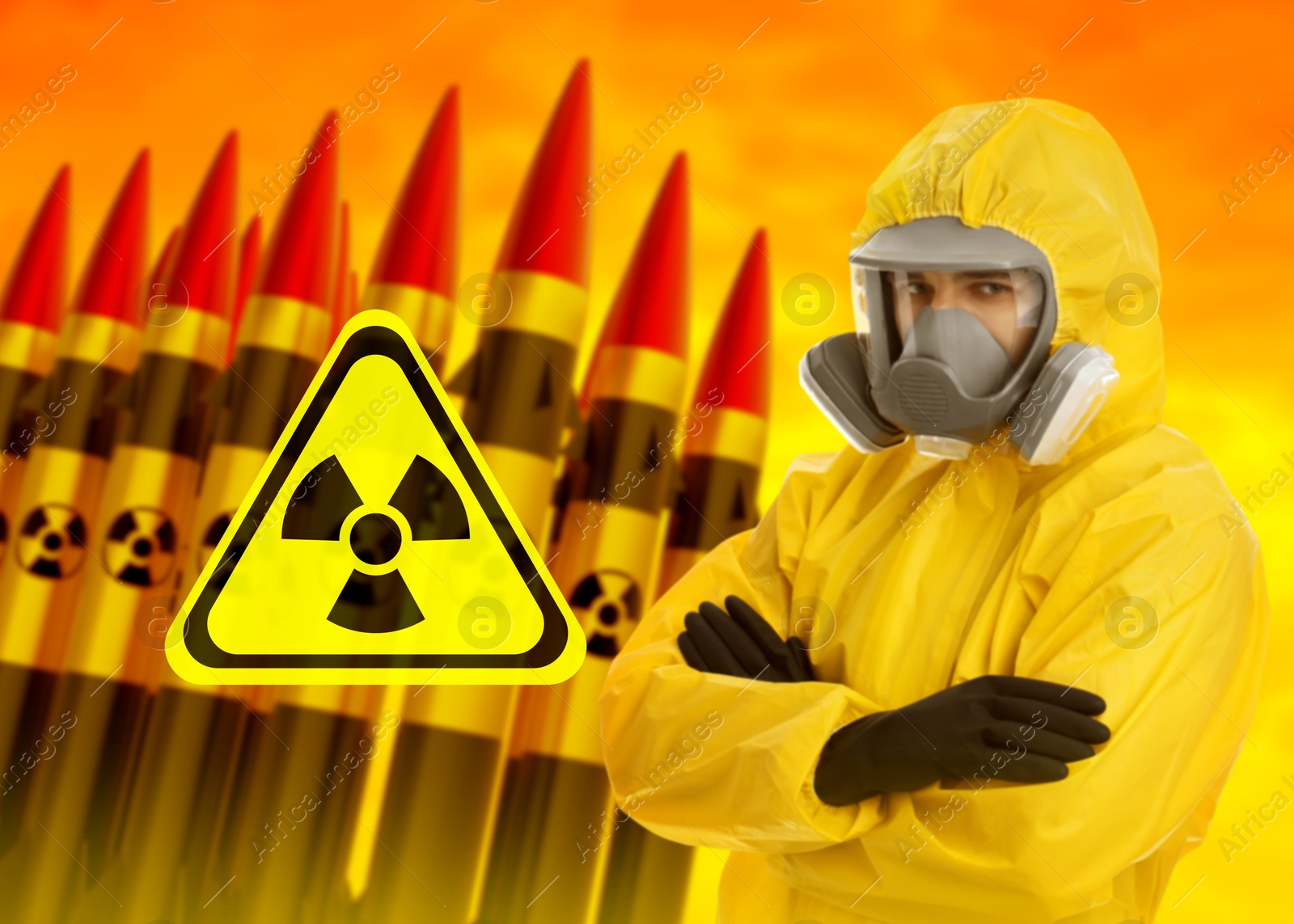 Man in hazmat suit and gas mask against missiles with radioactive signs Image of Man in hazmat suit and gas mask against missiles with radioactive signs