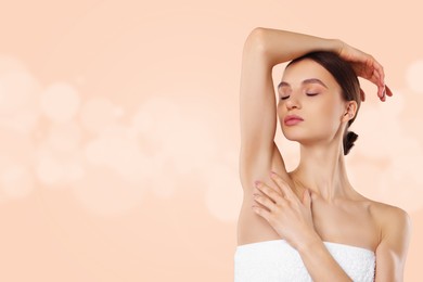 Image of Armpit epilation. Woman showing smooth underarms after hair removal against beige background