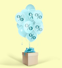 Image of Light blue balloons with percent signs and gift box on beige background. Hot sale, special offer